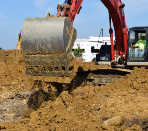 digger making progress on site excavation for Abode Excavation